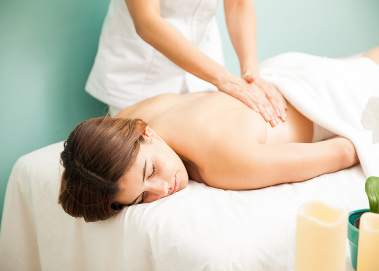 attractive-young-hispanic-woman-getting-back-massage-from-female-therapist-at-spa.jpg